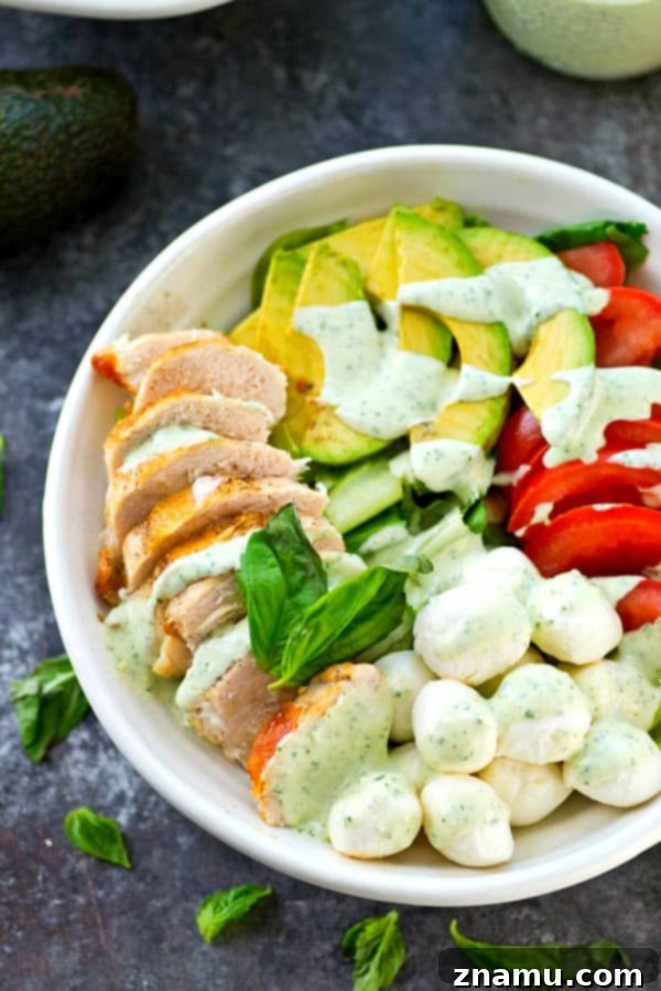 Pan-seared chicken, avocado, and a creamy flavorful pesto dressing spice up this colorful and massively flavor-packed caprese salad!