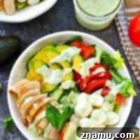 Pan-seared chicken, avocado, and a creamy flavorful pesto dressing spice up this colorful and massively flavor-packed caprese salad!