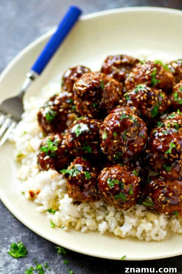Easy Asian Style Turkey Meatballs in 30 Minutes 3 Close-up of Asian-style turkey meatballs simmering in a rich homemade teriyaki sauce, showcasing their glossy glaze.