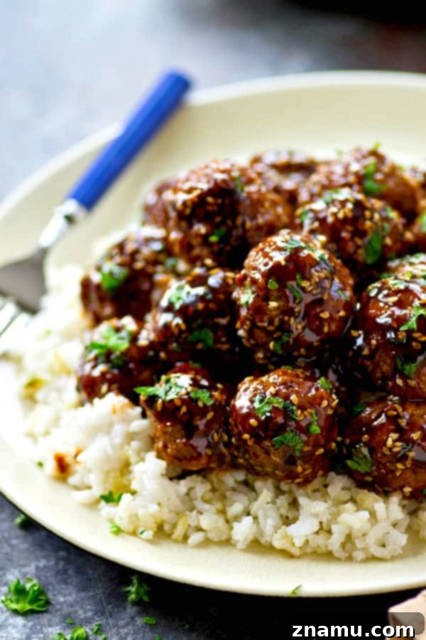 Easy Asian Style Turkey Meatballs in 30 Minutes 5 A mound of perfectly glazed Asian-style turkey meatballs piled high on a serving plate.