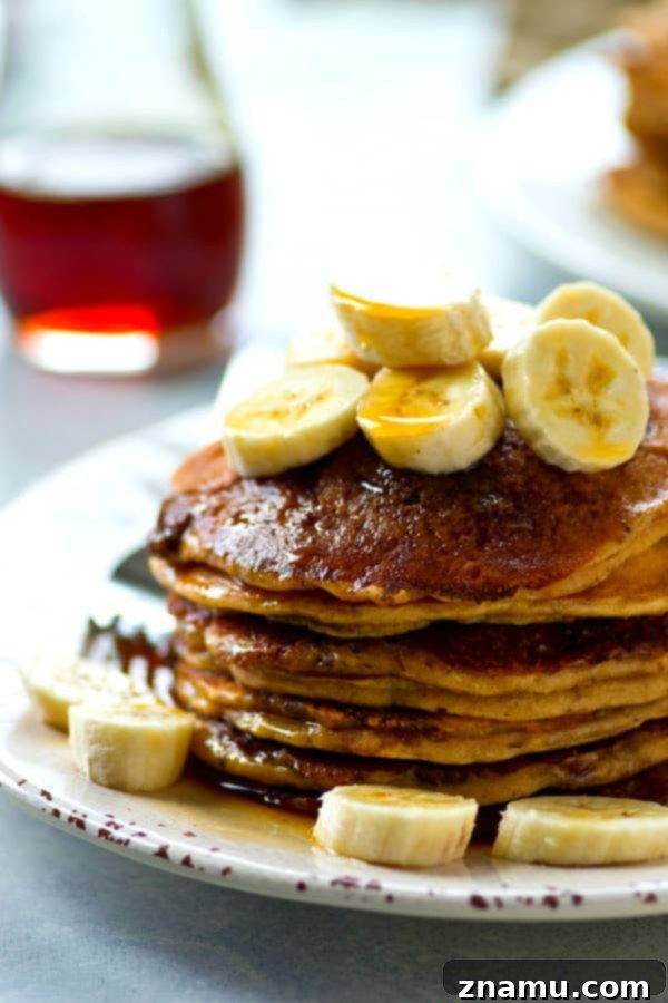Deliciously thick and fluffy banana buttermilk pancakes featuring a homemade cinnamon crunch topping