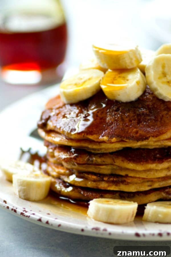 A close-up of fluffy banana buttermilk pancakes with cinnamon crunch, ready to be devoured