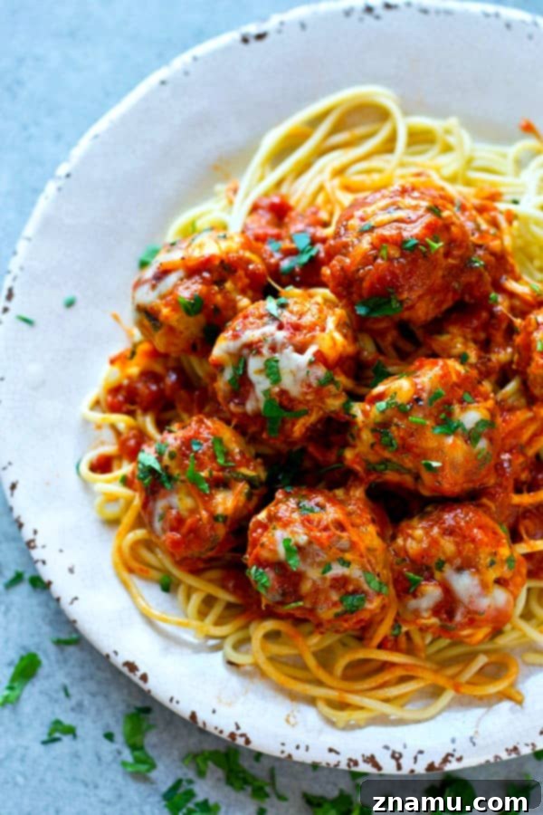Cheesy Instant Pot Chicken Parmesan Meatballs 5 Several Instant Pot Chicken Parmesan Meatballs covered in melted mozzarella cheese, ready to be served.