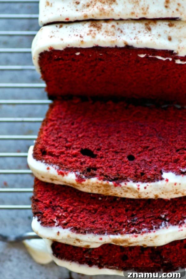 Soft, buttery red velvet pound cake covered in a tangy cream cheese glaze is a breeze to throw together and it's an insanely impressive dessert for any of your loved ones!