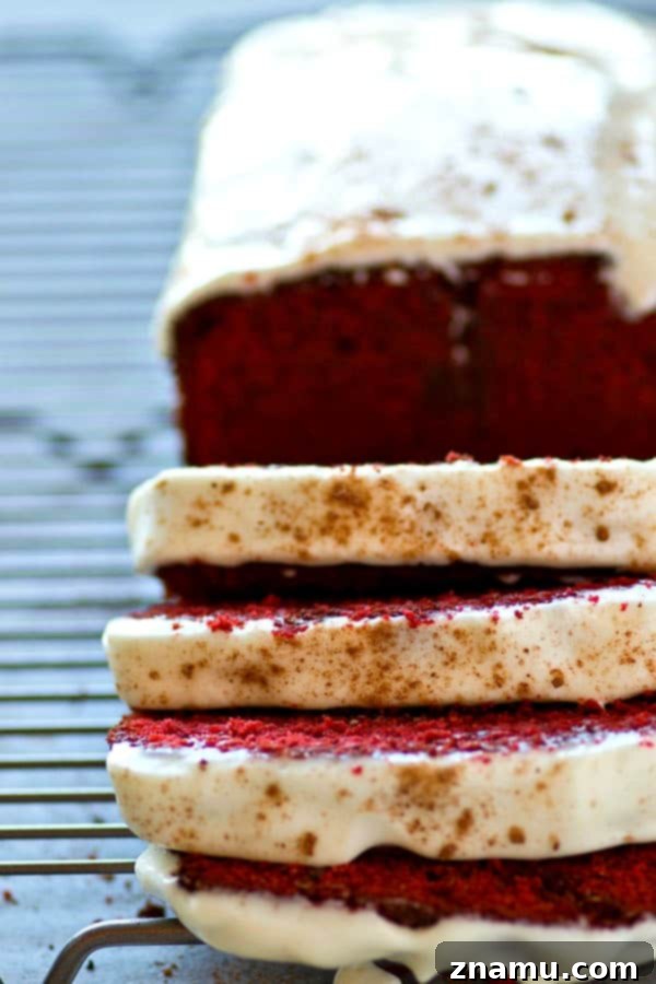 Soft, buttery red velvet pound cake covered in a tangy cream cheese glaze is a breeze to throw together and it's an insanely impressive dessert for any of your loved ones!