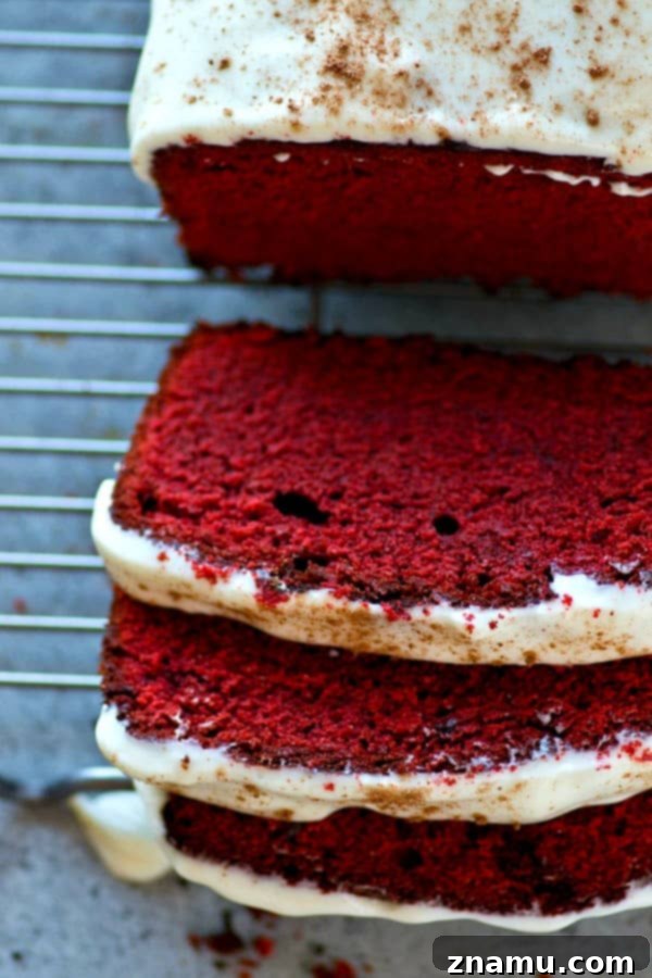 Soft, buttery red velvet pound cake covered in a tangy cream cheese glaze is a breeze to throw together and it's an insanely impressive dessert for any of your loved ones!