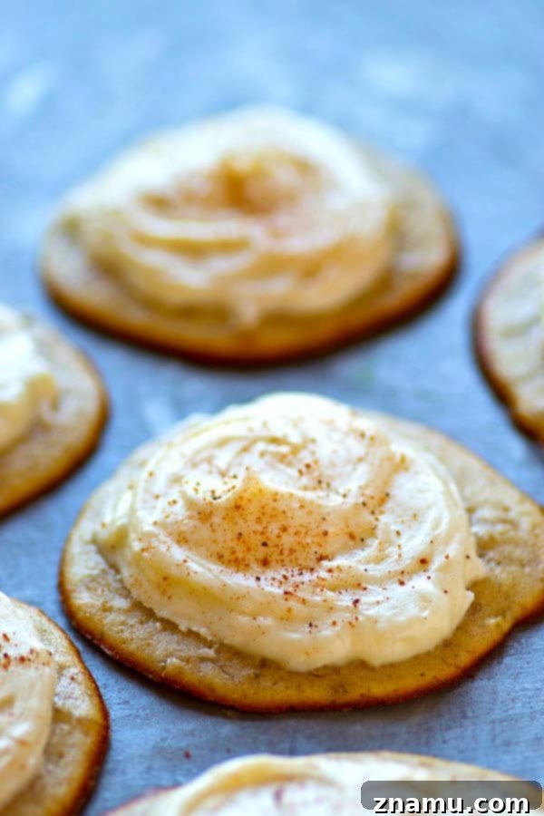 Irresistible Banana Bread Muffin Tops with Cream Cheese Frosting 5 Overhead view of several freshly baked banana bread muffin tops on a cooling rack