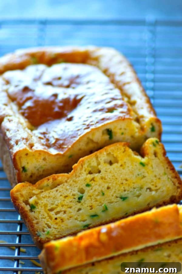 Zesty Cheddar Jalapeno Quick Loaf 5 A baked loaf of Cheesy Jalapeño Cheddar Quick Bread cooling on a wire rack, ready to be sliced and served.