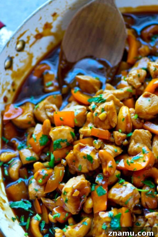 Zesty Ginger Cashew Chicken Stir-Fry with Sweet Peppers 5 Delicious Sweet Pepper Ginger Cashew Chicken Stir-Fry served in a bowl, garnished with fresh herbs
