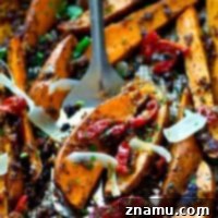 Tangy Pesto Roasted Sweet Potato Wedges 7 Roasted in a flavorful homemade sun-dried tomato pesto and covered in shaved Parmesan, these sweet potato wedges are SUCH an easy dinner side and you'll be eating them straight off the pan.