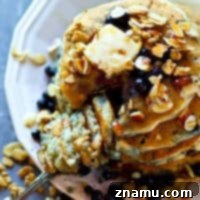 Golden Blueberry Granola Stacks, Drizzled with Almond Syrup 7 Juicy blueberries and crunchy granola are the ultimate duo in these SUPER thick and fluffy blueberry granola pancakes! Drizzle them with tons of almond syrup for a breakfast winner!