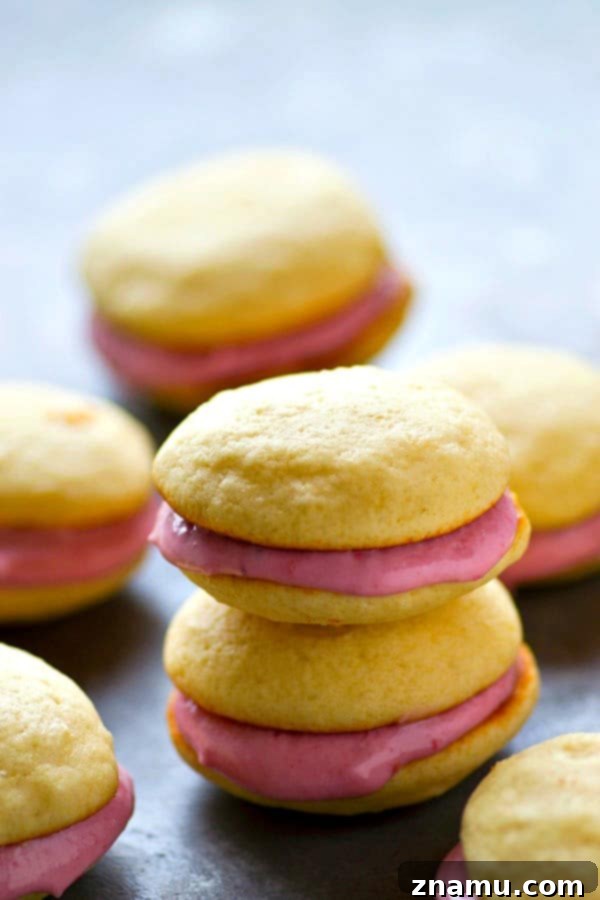 Vanilla Raspberry Cheesecake Whoopie Dreams 2 Delicious vanilla whoopie pie with raspberry cream cheese filling on a wooden surface
