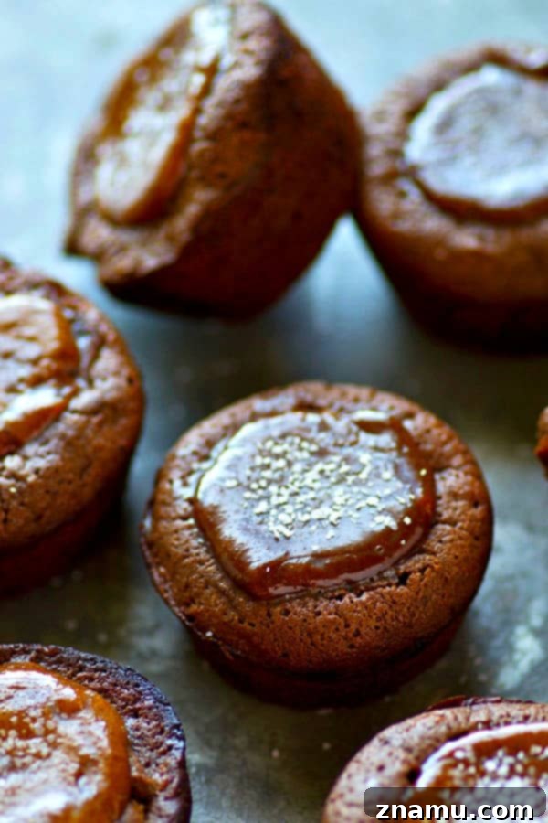 A batch of homemade dark chocolate brownie cups, perfectly baked and awaiting their luscious salted caramel filling.