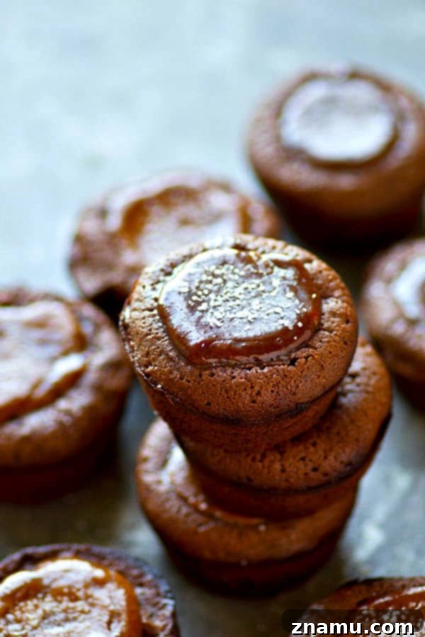 Close-up of a dark chocolate brownie cup with a perfectly indented center, prepared for salted caramel.