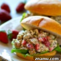 Toasted Almond Poppyseed Chicken Salad with Sweet Strawberries 7 Strawberry Almond Poppyseed Chicken Salad - a delightful blend of juicy strawberries, crunchy almonds, and poppyseeds, perfect for spring.