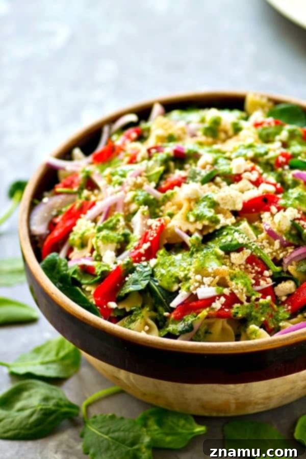 Mediterranean Roasted Red Pepper Feta Pasta Salad with Basil Vinaigrette 2 Delicious Roasted Red Pepper Feta Pasta Salad with fresh basil leaves, perfect for a summer picnic