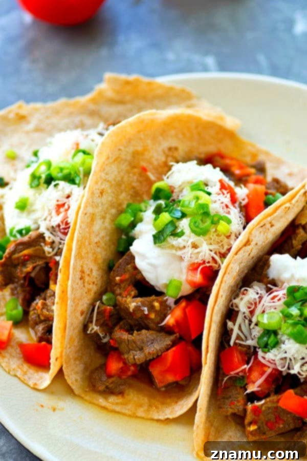 Instant Pot Fiery Beef and Bell Pepper Fajitas 2 Instant Pot Spicy Beef Fajitas with vibrant sweet peppers, ready to serve in tortillas.