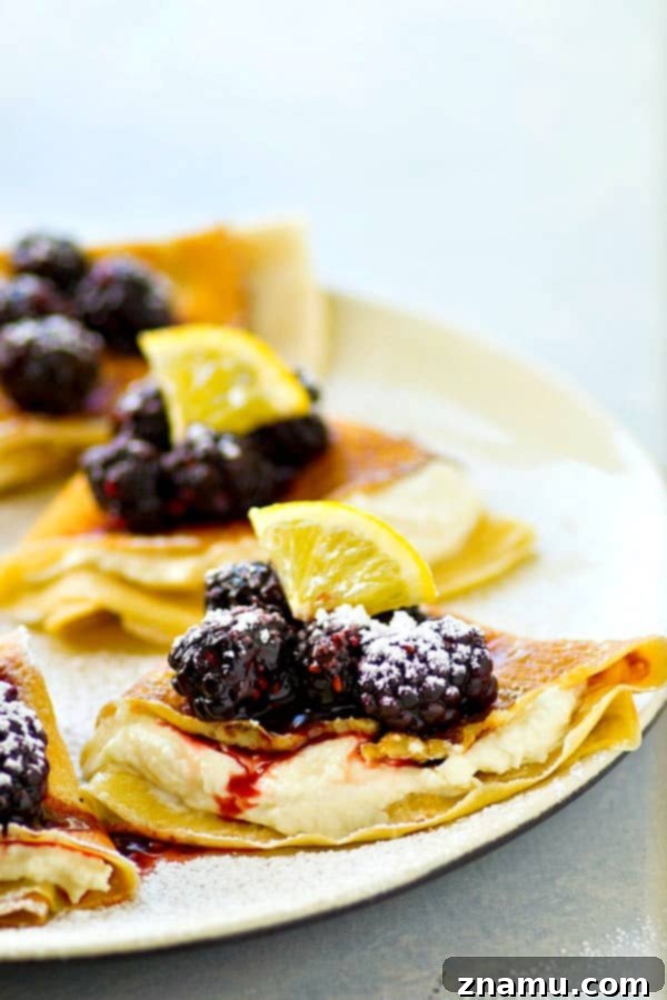 Stack of thin, golden crepes ready to be filled, highlighting their delicate texture
