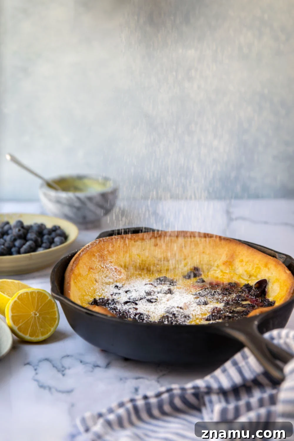 This blueberry lemon curd dutch baby combines juicy blueberries and tangy homemade lemon curd all piled into a big, flaky skillet dutch baby. Easy to make and a brunch favorite!