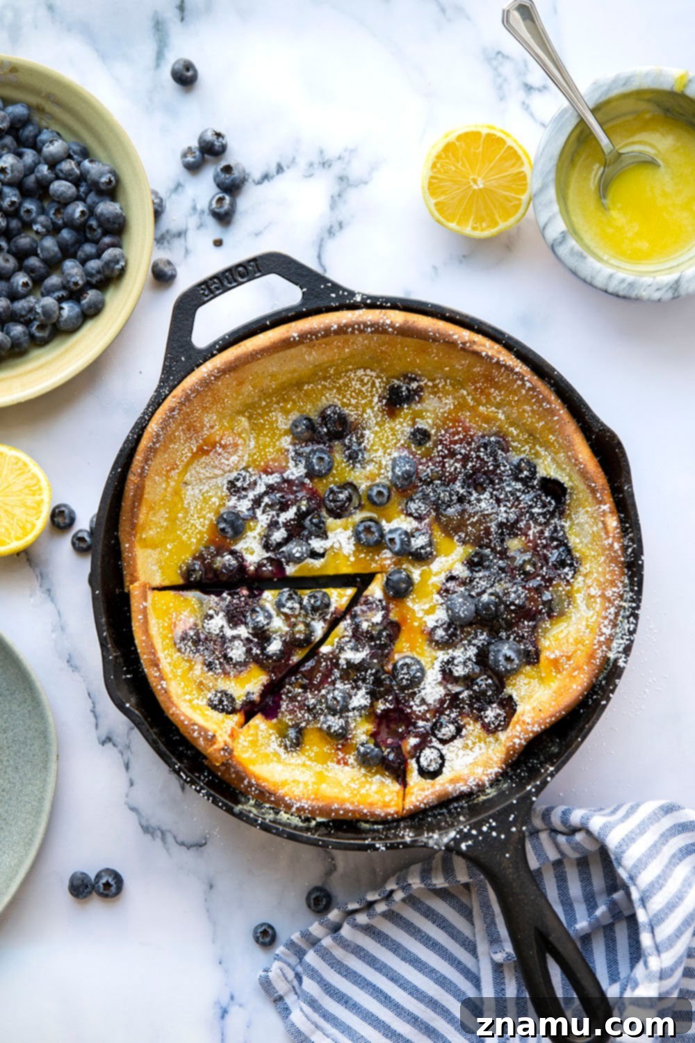 This blueberry lemon curd dutch baby combines juicy blueberries and tangy homemade lemon curd all piled into a big, flaky skillet dutch baby. Easy to make and a brunch favorite!