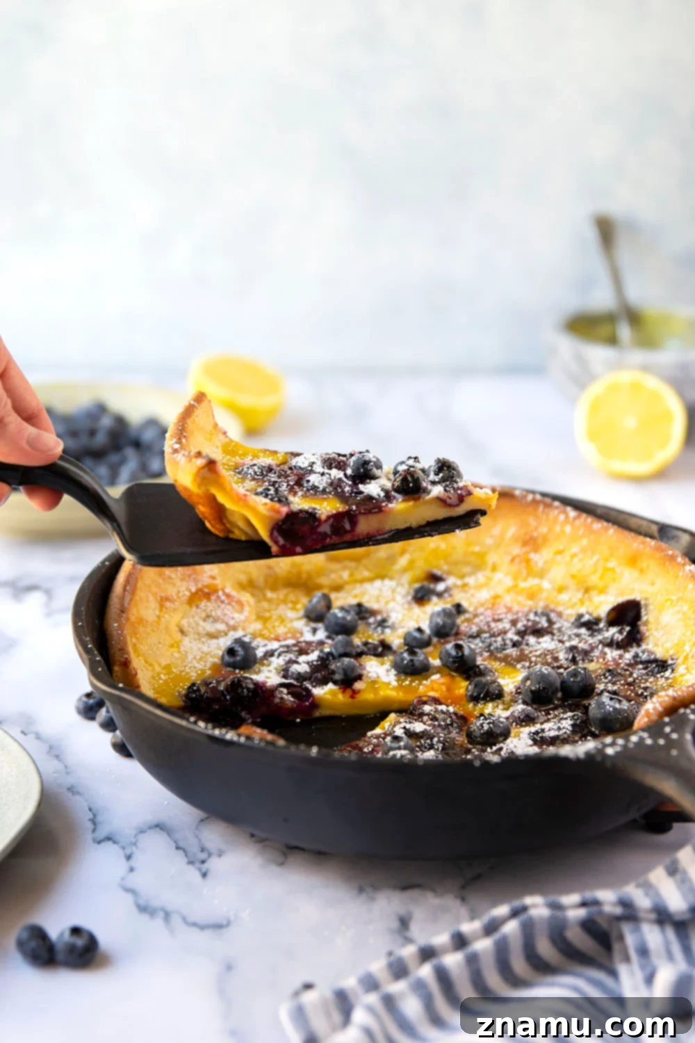 This blueberry lemon curd dutch baby combines juicy blueberries and tangy homemade lemon curd all piled into a big, flaky skillet dutch baby. Easy to make and a brunch favorite!