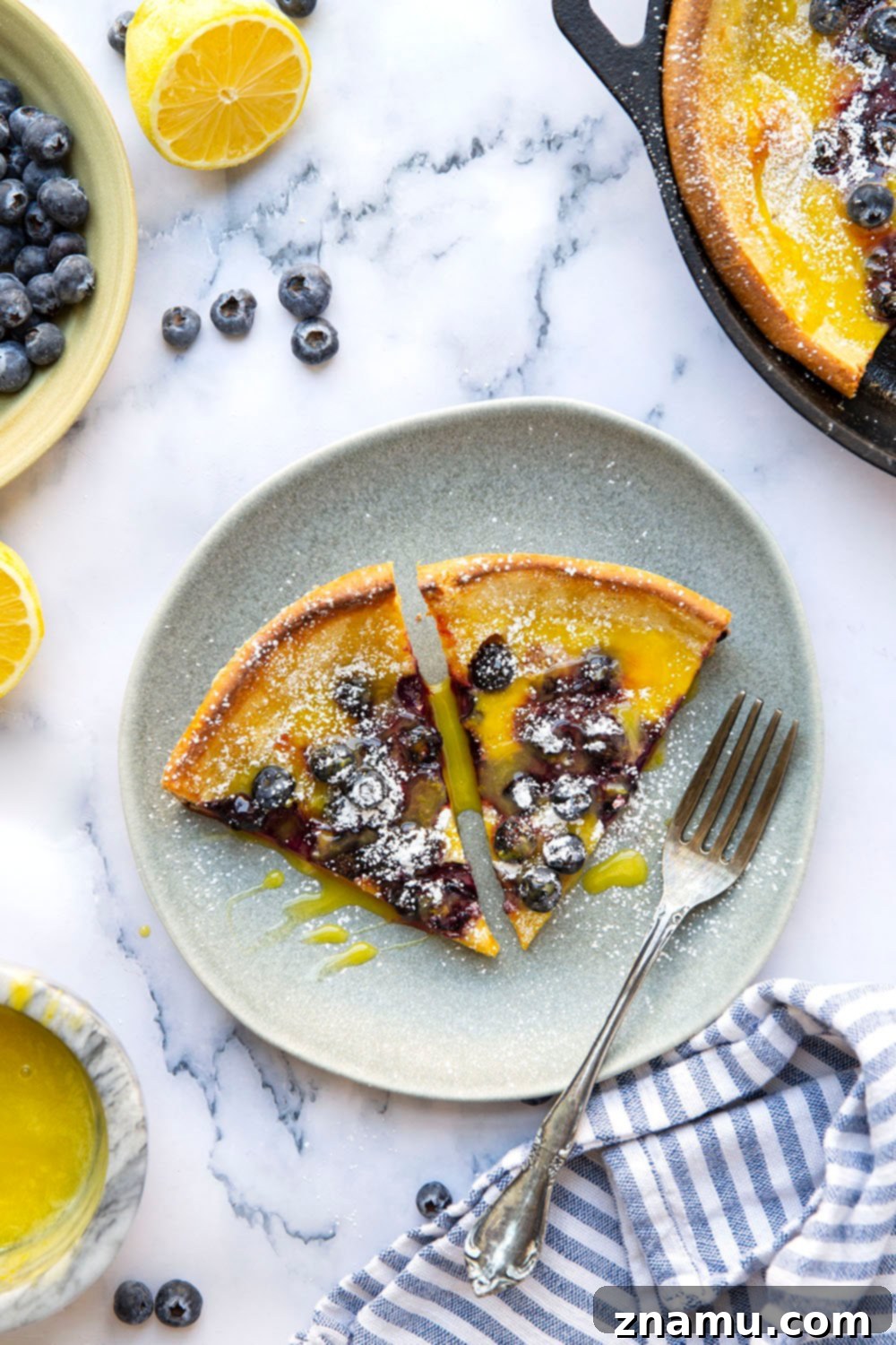 This blueberry lemon curd dutch baby combines juicy blueberries and tangy homemade lemon curd all piled into a big, flaky skillet dutch baby. Easy to make and a brunch favorite!