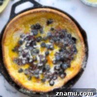 This blueberry lemon curd dutch baby combines juicy blueberries and tangy homemade lemon curd all piled into a big, flaky skillet dutch baby. Easy to make and a brunch favorite!