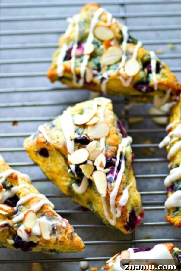 Creamy Blueberry Almond Scones 4 Delicious Blueberry Almond Scones arranged beautifully on a serving plate