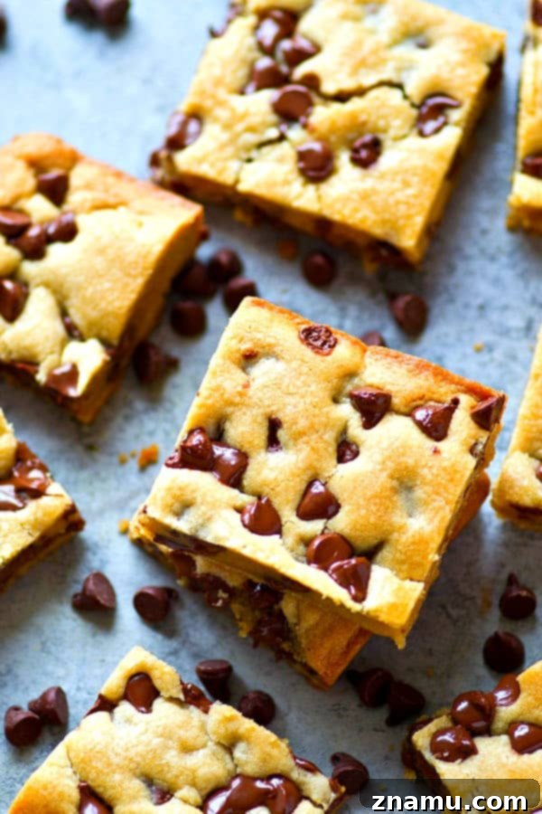 Gooey Coconut Oil Chocolate Chip Bars 2 A close-up of a perfectly soft-baked coconut oil chocolate chip cookie bar with gooey melted chocolate chips.