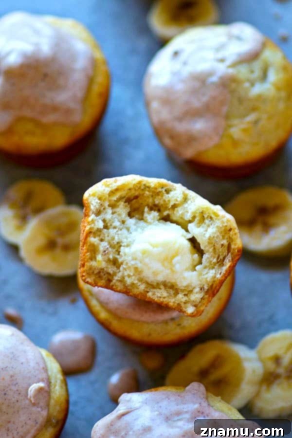 Comforting Banana Cream Cheese Muffins with Spiced Chai Glaze 2 Fluffy banana cream cheese muffins topped with a sweet, spicy chai glaze, ready for serving.