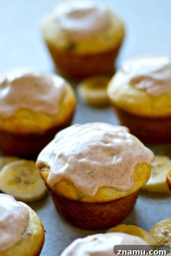 Comforting Banana Cream Cheese Muffins with Spiced Chai Glaze 3 A close-up of a freshly baked banana cream cheese muffin, revealing the soft texture and golden-brown top.