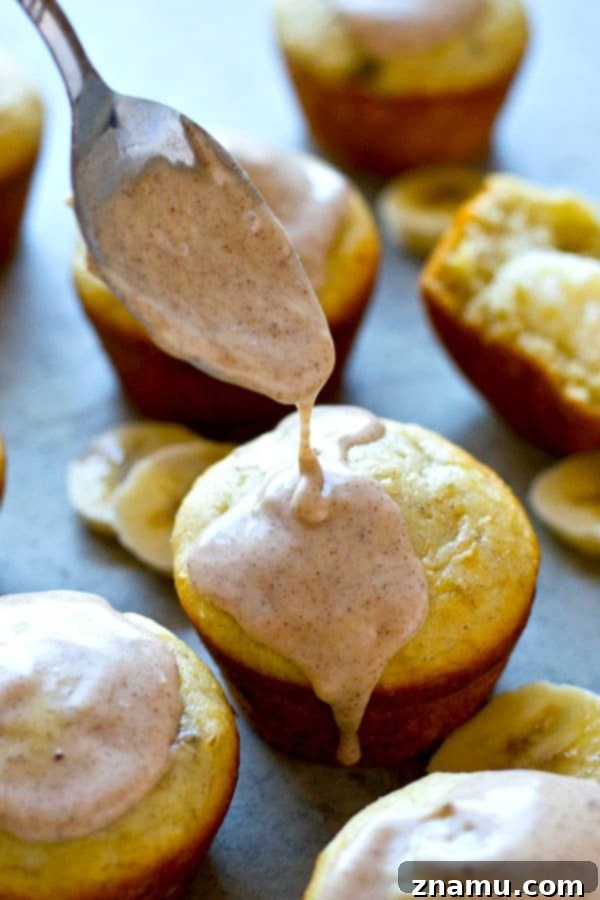 Comforting Banana Cream Cheese Muffins with Spiced Chai Glaze 5 A close-up shot of a banana cream cheese muffin, showcasing the gooey cream cheese filling and elegant chai glaze.