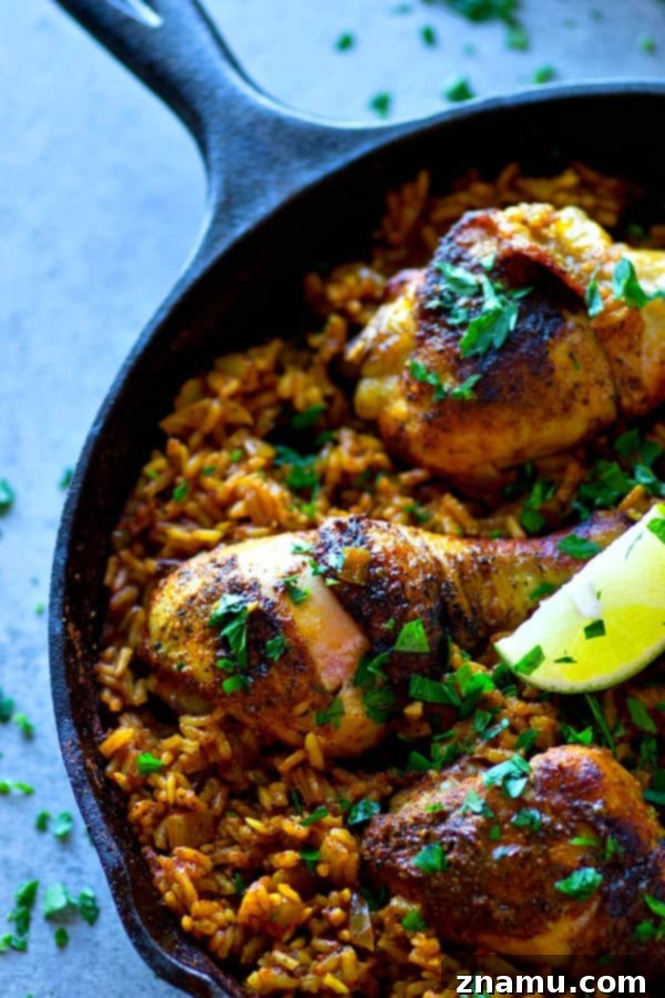 Spanish Skillet Chicken and Rice 2 Close-up of a Spanish chicken and rice skillet, showcasing juicy chicken legs and flavorful, spice-infused rice in a single pan.