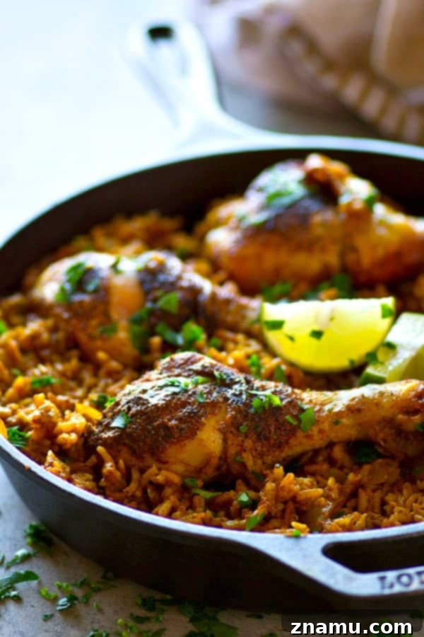 Spanish Skillet Chicken and Rice 5 One-pot Spanish chicken and rice skillet, ready to serve, garnished with fresh lime and cilantro.