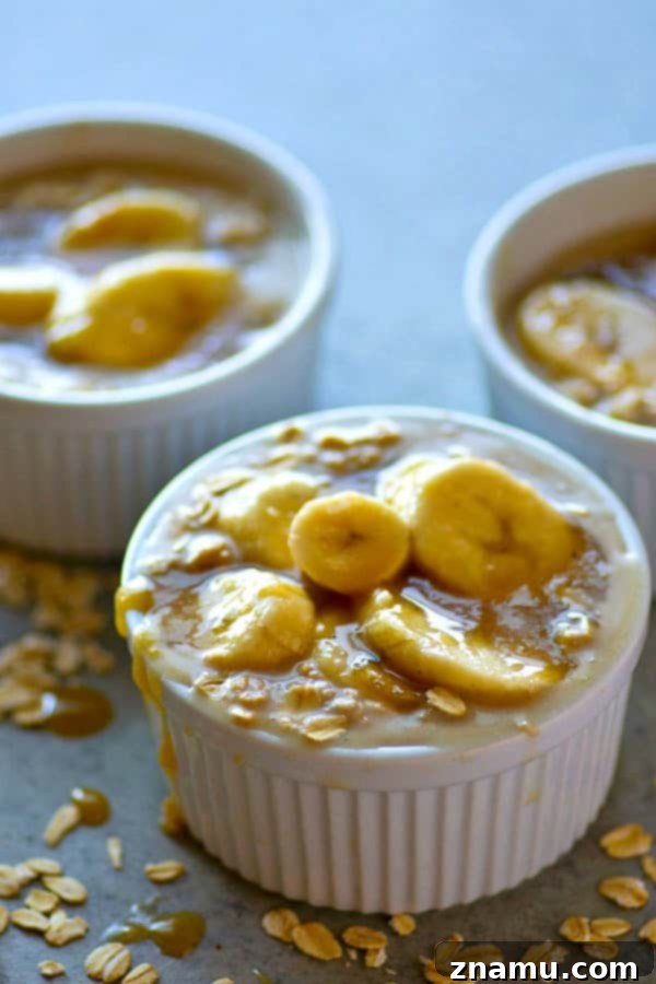 A beautifully presented jar of Caramel Macchiato Banana Overnight Oats, layered with creamy oats, sliced bananas, and drizzled with caramel sauce.