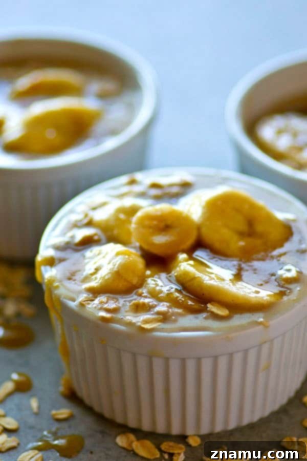 A generous serving of Caramel Macchiato Banana Overnight Oats in a bowl, topped with plenty of caramelized banana slices and a caramel drizzle.
