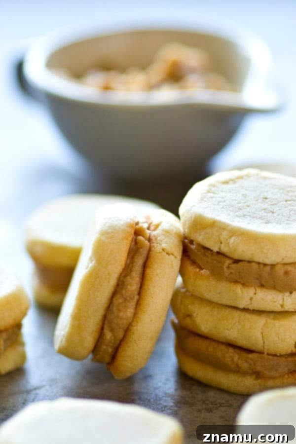 Vanilla Wafer Caramel Delights 2 Close-up of three vanilla wafer caramel sandwich cookies stacked, showing the golden-brown wafers and creamy caramel filling