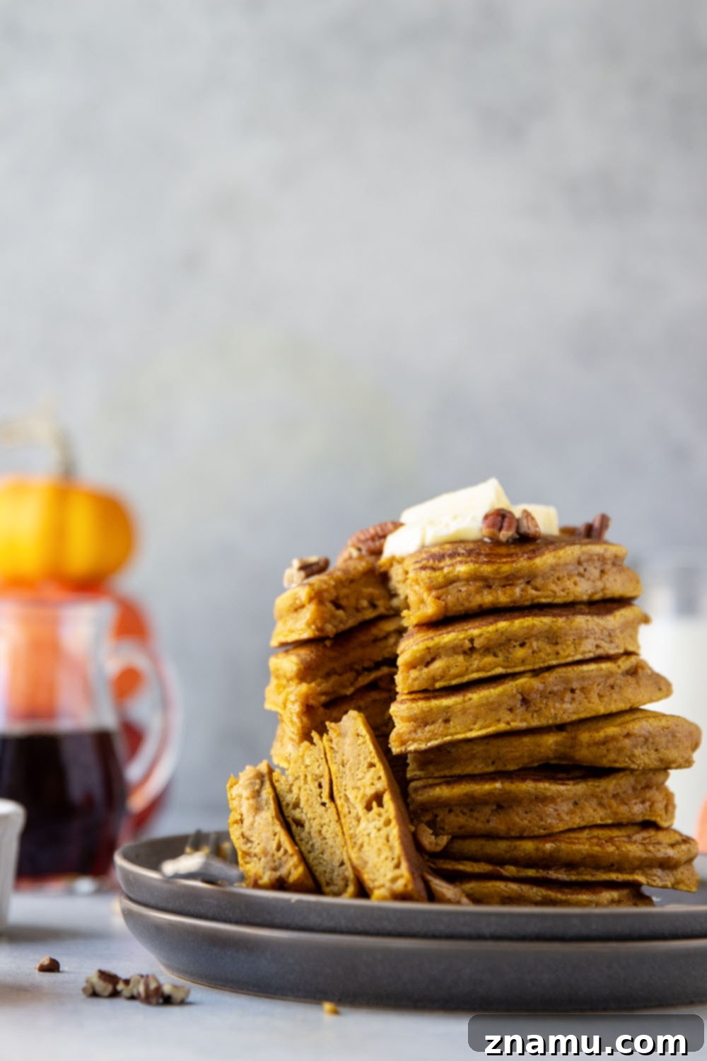Warm Spiced Pumpkin Stacks 5 Ingredients for pumpkin spice pancakes laid out on a kitchen counter: flour, spices, pumpkin puree, egg, milk, butter, and brown sugar.