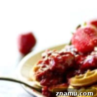 Crispy, rustic cornmeal waffles are topped with the BEST homemade strawberry preserves for the best summer breakfast you'll ever have.