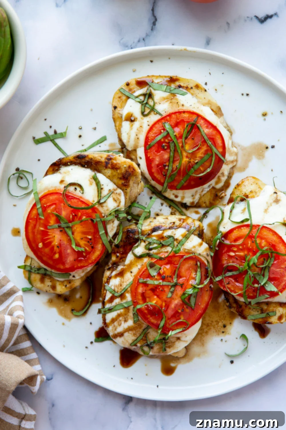 Grilled Caprese Chicken 3 This grilled chicken margherita features grilled chicken topped with fresh mozzarella, juicy tomato slices, and lots of fresh basil and balsamic glaze.