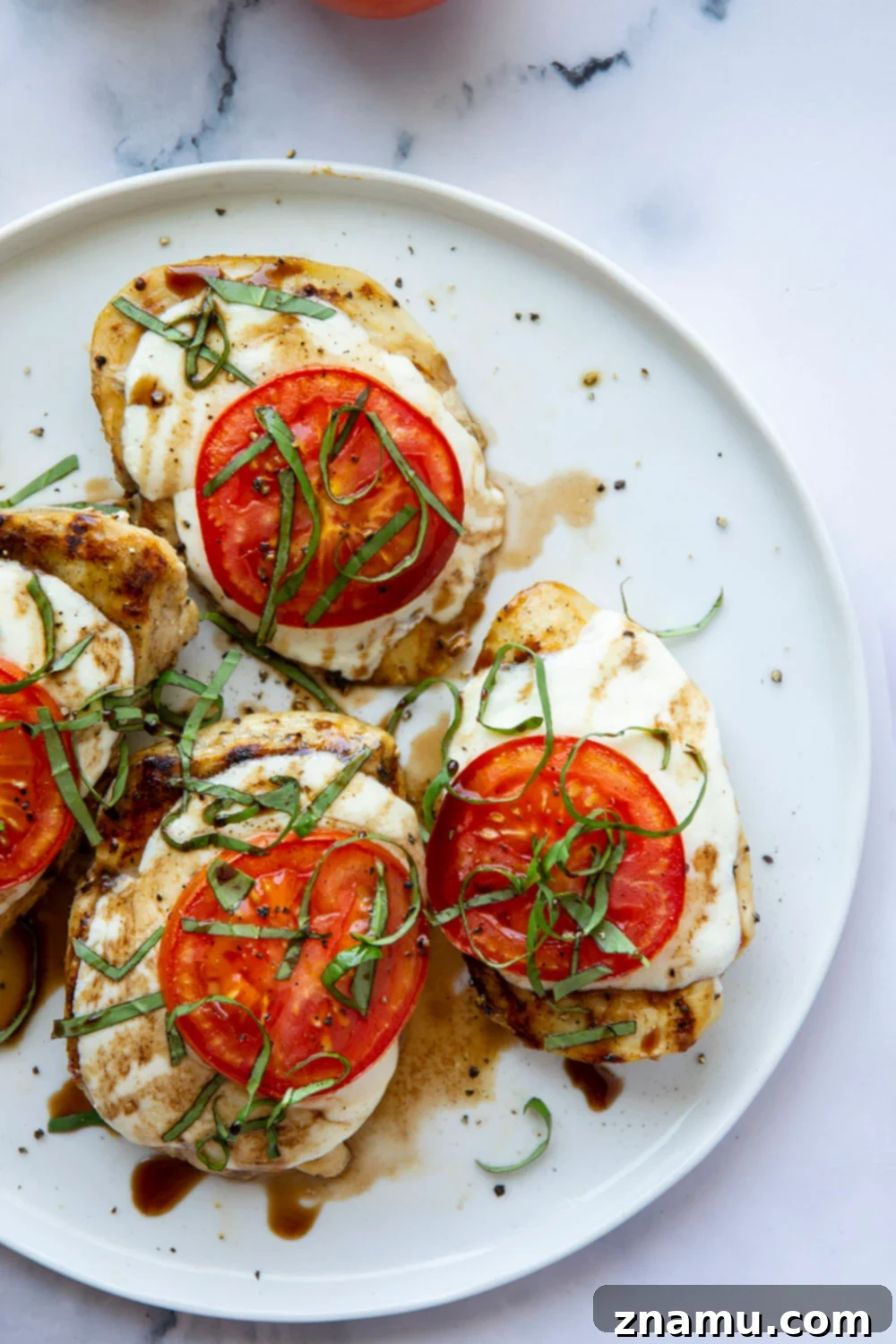 Grilled Caprese Chicken 4 This grilled chicken margherita features grilled chicken topped with fresh mozzarella, juicy tomato slices, and lots of fresh basil and balsamic glaze.
