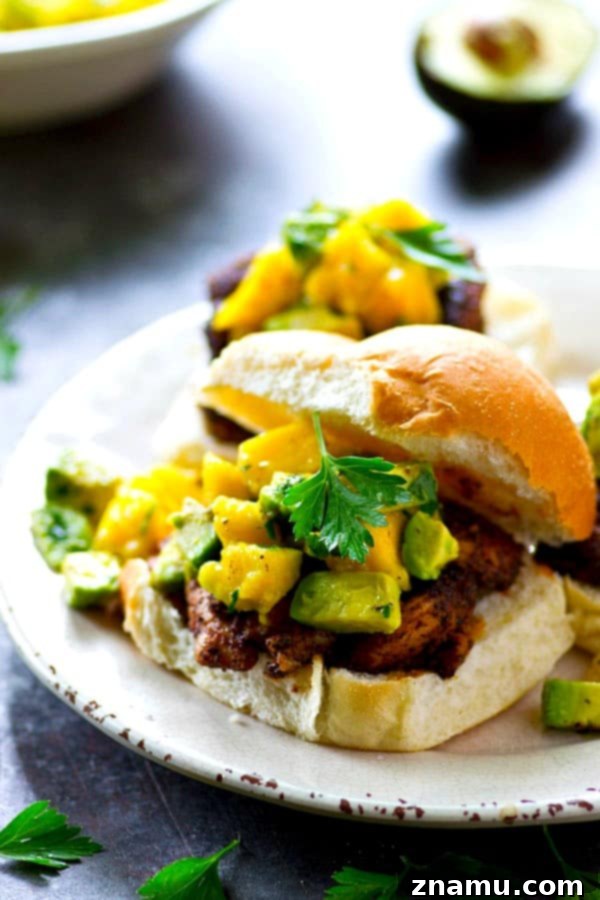 A smoky blackened spice rub coats every inch of these juicy grilled blackened chicken sandwiches and a silky mango avocado salsa is piled high on top for the ultimate summer sandwich!