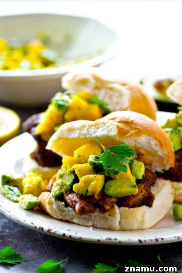 A smoky blackened spice rub coats every inch of these juicy grilled blackened chicken sandwiches and a silky mango avocado salsa is piled high on top for the ultimate summer sandwich!
