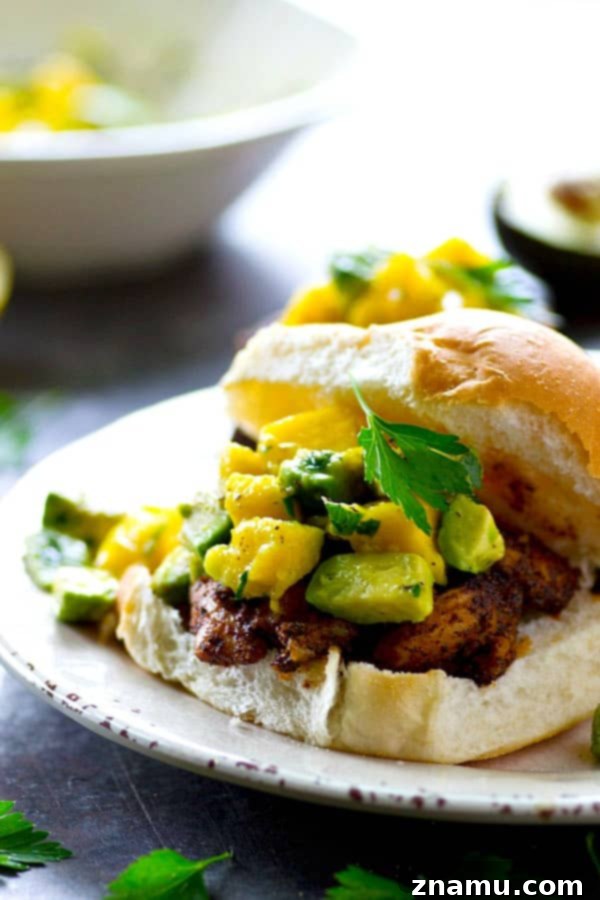 A smoky blackened spice rub coats every inch of these juicy grilled blackened chicken sandwiches and a silky mango avocado salsa is piled high on top for the ultimate summer sandwich!