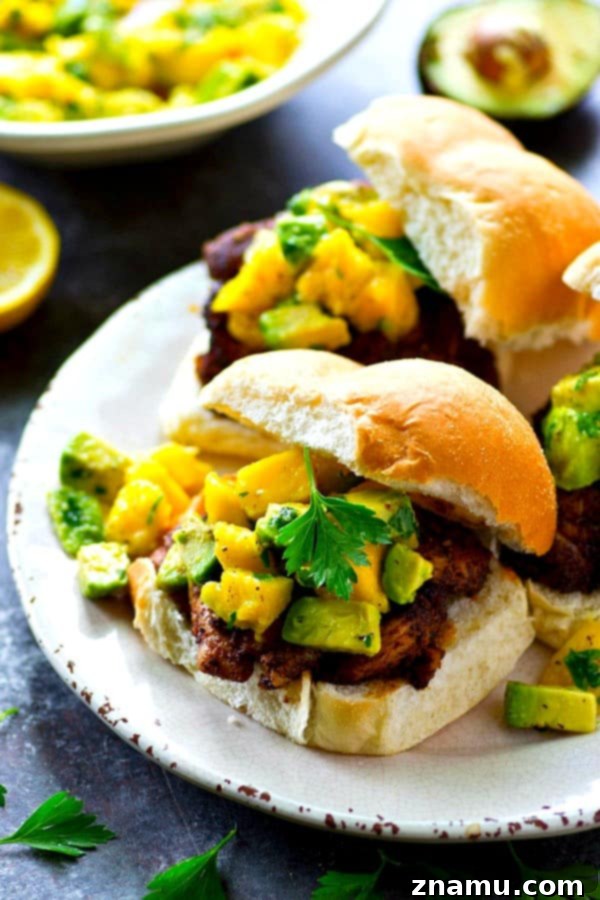 A smoky blackened spice rub coats every inch of these juicy grilled blackened chicken sandwiches and a silky mango avocado salsa is piled high on top for the ultimate summer sandwich!