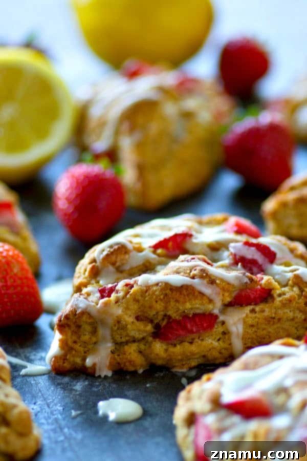 Tangy Strawberry Lemon Scones 3 Close-up of a perfectly baked strawberry lemonade scone, showcasing its flaky layers and golden-brown crust.