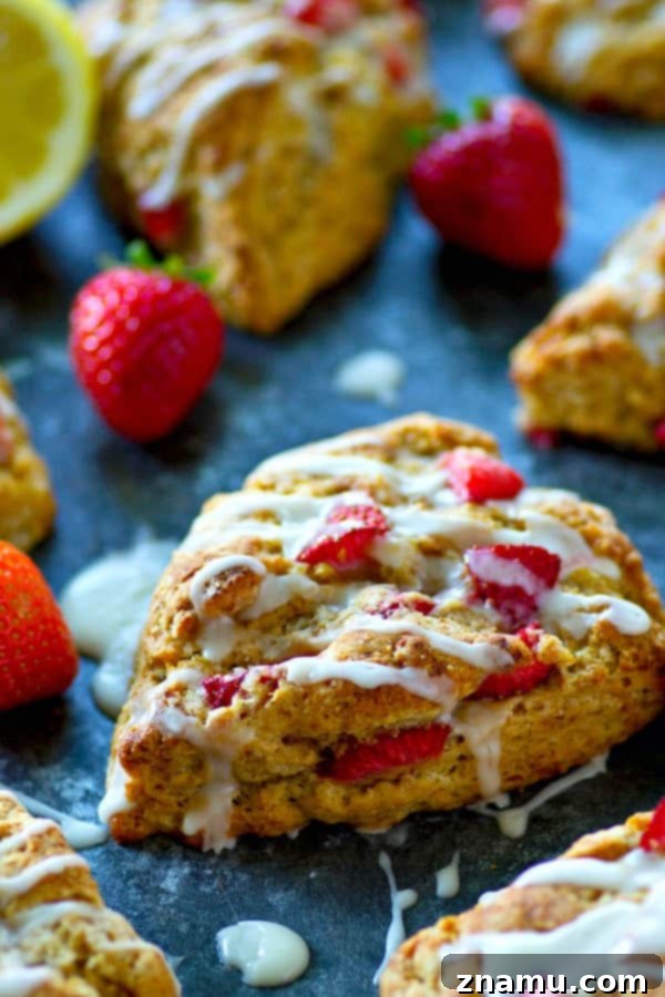 Tangy Strawberry Lemon Scones 5 Several glazed strawberry lemonade scones arranged on a cooling rack, showcasing the perfect texture and inviting glaze.