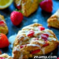 Tangy Strawberry Lemon Scones 7 A tangy lemon glaze and winning combo of strawberries and lemonade collide in these incredibly flaky strawberry lemonade scones.---Super easy to make and a brunch stunner!
