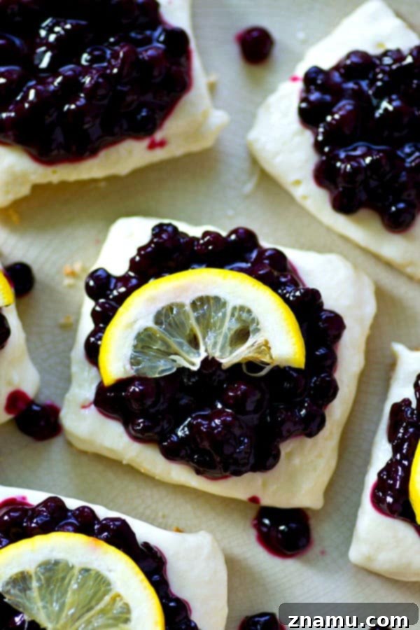 Refreshing No-Bake Blueberry Lemon Cheesecake Bars 4 Multiple no-bake blueberry lemon cheesecake bars arranged beautifully, featuring the distinct layers of crust, lemon cheesecake, and a shimmering blueberry sauce.