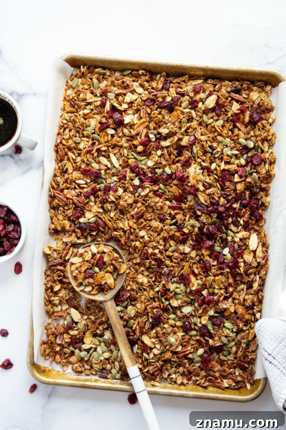 Sweet Maple Crunch 3 Close-up of golden-brown maple granola with whole nuts and vibrant dried cranberries.
